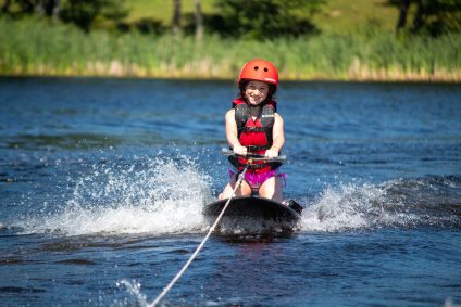 A camper on a waterski in the lake